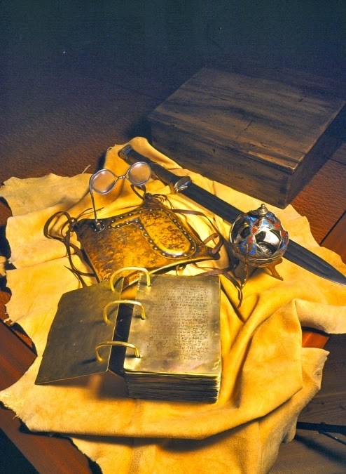 Mormon sacred golden plates, special glasses, liahona compass, and sword on cloth