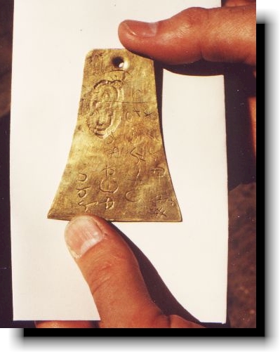 Fingers holding Kinderhook Plates