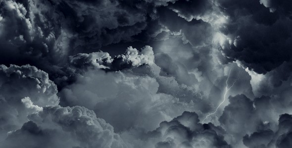 Dark and grey puffy storm clouds with hint of light and streak of lightning